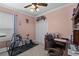 Bedroom featuring exercise equipment, a closet, and a pink wall color at 3562 Foxchase Dr, Clermont, FL 34711
