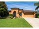 Inviting one-story home with lush green lawn, mature landscaping, and a convenient two-car garage at 3562 Foxchase Dr, Clermont, FL 34711