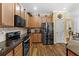 Well-equipped kitchen features stainless steel appliances, granite counters, and wood cabinetry at 3562 Foxchase Dr, Clermont, FL 34711