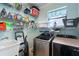 Functional laundry room with washer, dryer, utility sink, and shelving for storage and organization at 3562 Foxchase Dr, Clermont, FL 34711