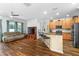 Open-concept living room with bar seating, a large TV, and wood-look flooring at 3562 Foxchase Dr, Clermont, FL 34711