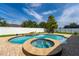 Beautiful pool with a spa and water feature in a fenced-in backyard with patio seating at 3562 Foxchase Dr, Clermont, FL 34711