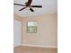 Bedroom with neutral paint, tiled floor, and bright window with blinds at 425 Walnut St, Daytona Beach, FL 32114