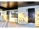 A covered entrance with two dark-painted doors offers shelter and style at 425 Walnut St, Daytona Beach, FL 32114
