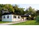 Exterior view of home with well maintained lawn, driveway and mature trees at 425 Walnut St, Daytona Beach, FL 32114