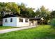 Exterior view of home with well maintained lawn, driveway and mature trees at 425 Walnut St, Daytona Beach, FL 32114