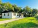Exterior view of home with well maintained lawn, driveway and mature trees at 425 Walnut St, Daytona Beach, FL 32114