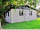 Exterior view of home with green grass and mature shade trees at 425 Walnut St, Daytona Beach, FL 32114
