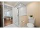 Well-lit bathroom with glass shower and bedroom view at 4621 S Atlantic Ave # 7202, Port Orange, FL 32127