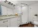 Bright bathroom features a large vanity with stone counter top, and glass shower at 4621 S Atlantic Ave # 7202, Port Orange, FL 32127