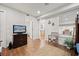 Bright bedroom featuring a TV, wood flooring, and sliding door at 4621 S Atlantic Ave # 7202, Port Orange, FL 32127