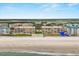 Exterior view of condo building with blue arrow indicating unit at 4621 S Atlantic Ave # 7202, Port Orange, FL 32127