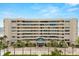 Elegant condo building with manicured landscaping and palm trees, offering a luxurious beachfront living experience at 4621 S Atlantic Ave # 7202, Port Orange, FL 32127