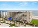 Exterior view of condo building with blue arrow indicating unit at 4621 S Atlantic Ave # 7202, Port Orange, FL 32127