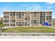 Exterior view of condo building from beachside with blue arrow indicating unit at 4621 S Atlantic Ave # 7202, Port Orange, FL 32127