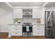 Well-equipped kitchen with stainless steel appliances, white cabinets, and granite countertops for a modern cooking experience at 4621 S Atlantic Ave # 7202, Port Orange, FL 32127