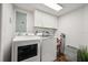 Convenient laundry room with modern washer and dryer units, storage cabinets, and a utility sink at 4621 S Atlantic Ave # 7202, Port Orange, FL 32127
