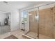 Bathroom featuring glass enclosed shower, tiled walls and floor, and a window with natural light at 4759 Riverwalk Dr, St Cloud, FL 34771