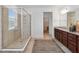Bright bathroom with a glass shower, double sink vanity with granite countertops, and a neutral color palette at 4759 Riverwalk Dr, St Cloud, FL 34771