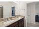 Well-lit bathroom featuring a double sink vanity with granite countertops and a large mirror, creating a spa-like feel at 4759 Riverwalk Dr, St Cloud, FL 34771