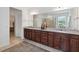 Elegant bathroom featuring a long vanity with granite countertops and a large mirror at 4759 Riverwalk Dr, St Cloud, FL 34771