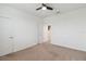 Bedroom featuring plush carpet flooring, a ceiling fan, and a doorway to another room at 4759 Riverwalk Dr, St Cloud, FL 34771