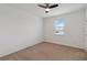 Cozy bedroom with plush carpet flooring, a ceiling fan, and a window with a view at 4759 Riverwalk Dr, St Cloud, FL 34771