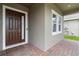 The entryway features a brick-paved porch and a solid front door with side window at 4759 Riverwalk Dr, St Cloud, FL 34771