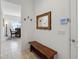 Inviting entryway with decorative mirror, wooden bench, and smart home control panel at 4759 Riverwalk Dr, St Cloud, FL 34771