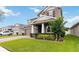 Beautiful two-story home with a well-maintained lawn, brick-paved driveway, and covered front entrance at 4759 Riverwalk Dr, St Cloud, FL 34771
