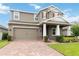 Charming two-story home with a two-car garage, brick-accented facade, and neatly landscaped front yard at 4759 Riverwalk Dr, St Cloud, FL 34771