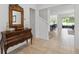 Inviting foyer with tile floors, antique mirror, and stairs to the second floor at 4759 Riverwalk Dr, St Cloud, FL 34771