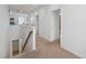 Upstairs hallway featuring plush carpet and a decorative wood and metal staircase at 4759 Riverwalk Dr, St Cloud, FL 34771