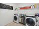 Bright laundry room with modern washer and dryer, plenty of storage space, and tiled floors at 4759 Riverwalk Dr, St Cloud, FL 34771