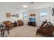 Cozy living room featuring carpet flooring, natural light, and comfortable seating at 4759 Riverwalk Dr, St Cloud, FL 34771