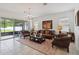 Elegant living room featuring tile flooring, a chandelier, and sliding glass doors to the backyard at 4759 Riverwalk Dr, St Cloud, FL 34771