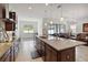 Open-concept kitchen featuring dark wood cabinets, granite counters, and easy access to living areas at 4759 Riverwalk Dr, St Cloud, FL 34771