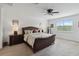 Spacious main bedroom featuring a ceiling fan and views of lush green trees through the window at 4759 Riverwalk Dr, St Cloud, FL 34771