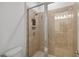Tiled walk-in shower with sleek glass door and recessed shelf, designed for relaxation at 4759 Riverwalk Dr, St Cloud, FL 34771