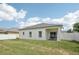 Spacious backyard with lush green grass and a cozy covered patio, great for outdoor activities at 504 Key Haven Dr, Sanford, FL 32771