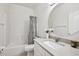 Clean bathroom features a shower-tub combo, white vanity with round mirror, and neutral finishes at 504 Key Haven Dr, Sanford, FL 32771