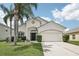 Charming single-Gathering home with mature palm trees and a well-manicured lawn at 504 Key Haven Dr, Sanford, FL 32771