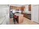 Modern kitchen with stainless steel appliances, granite countertops, an island, and wooden cabinets at 504 Key Haven Dr, Sanford, FL 32771