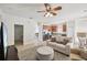 Inviting living room open to the kitchen features a ceiling fan and neutral decor at 504 Key Haven Dr, Sanford, FL 32771