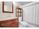 Bathroom featuring a wood vanity, toilet and stand alone shelving at 5323 Hansel Ave # E14, Orlando, FL 32809