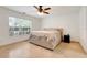 Bedroom with large window, fan, neutral colored walls and tile flooring at 5323 Hansel Ave # E14, Orlando, FL 32809