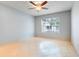 Bright, empty bedroom featuring a large window and neutral colored walls at 5323 Hansel Ave # E14, Orlando, FL 32809