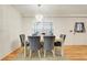 Cozy dining area with a modern table set, stylish chairs, and a window with natural light at 5323 Hansel Ave # E14, Orlando, FL 32809