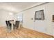 Bright dining room with a modern table, stylish chairs, and hardwood floors at 5323 Hansel Ave # E14, Orlando, FL 32809