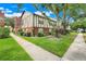 Exterior shot showcasing the property's architecture and manicured green spaces at 5323 Hansel Ave # E14, Orlando, FL 32809